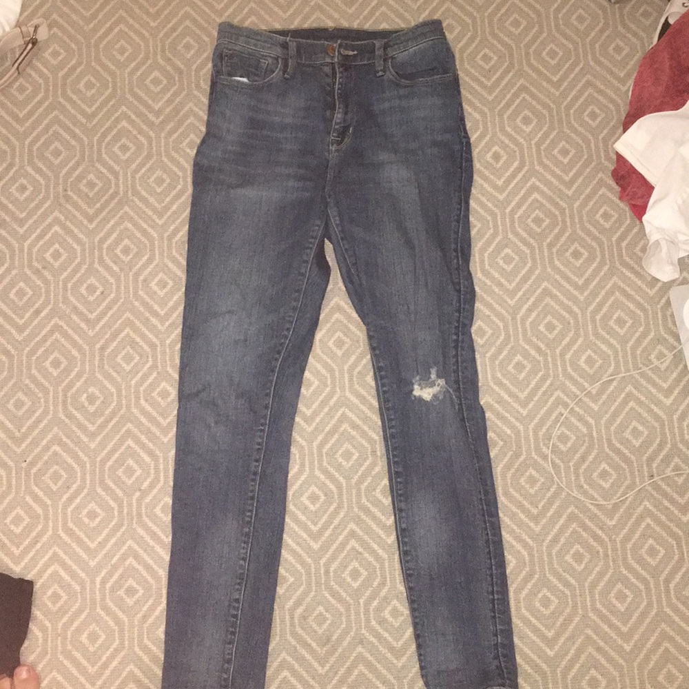 high waisted jeans with rip in one knee
